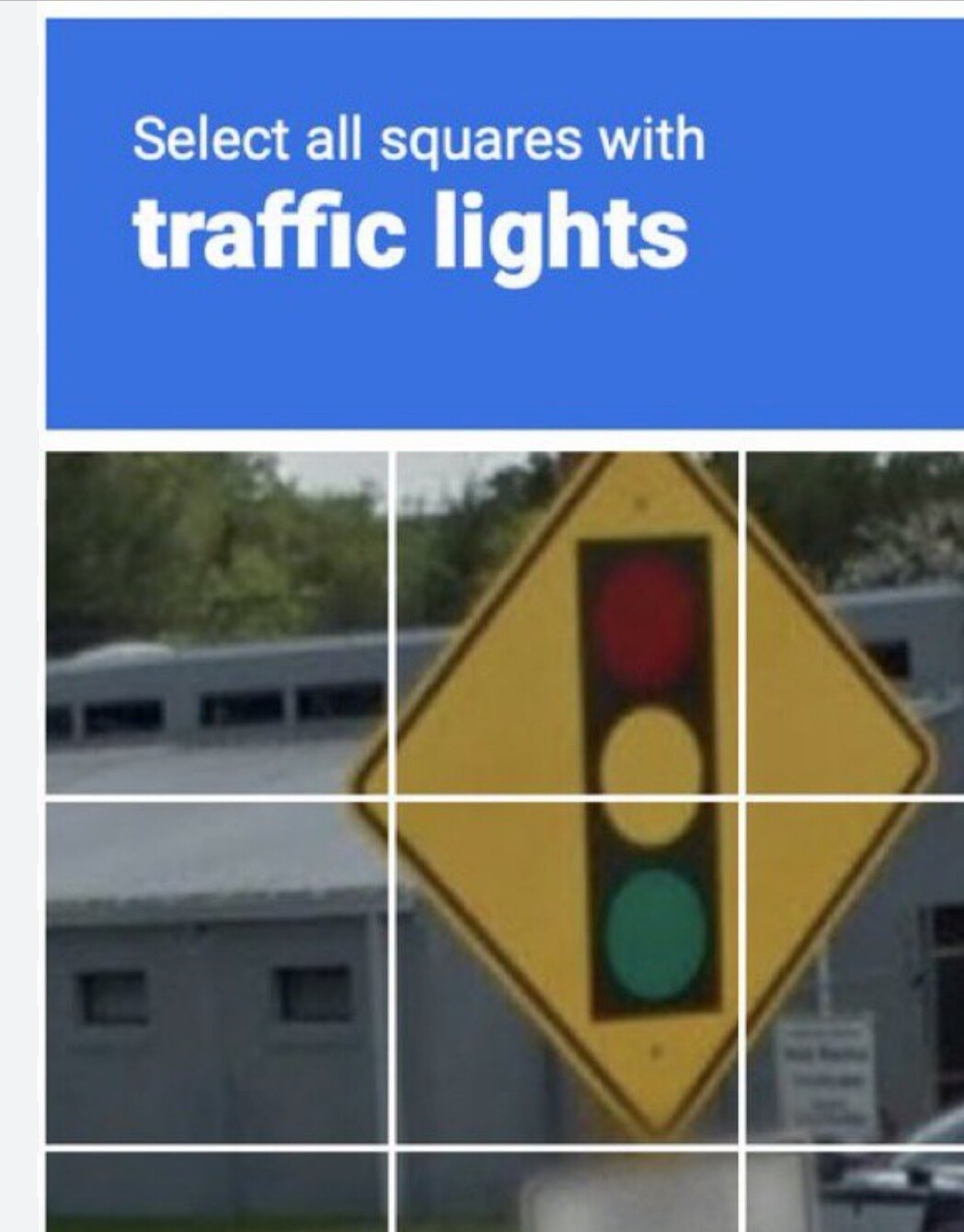 Screenshot of one of those ubiquitous train-my-AI-please are-you-human test, showing a picture of an amber diamond sign with a graphic of a traffic semaphore on it, above which the user is instructed "Select all squares with traffic lights"